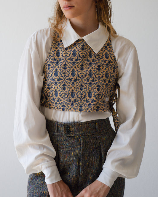 A woman is wearing a Blue Paisley Australian handmade top in front of a white wall